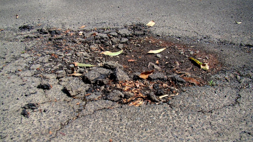 Pothole on bitumen road.