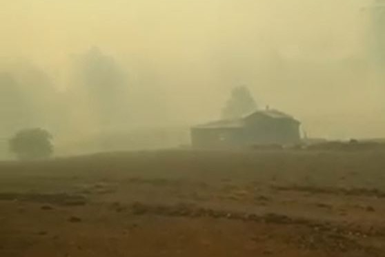 Thick smoke around a small house in the country