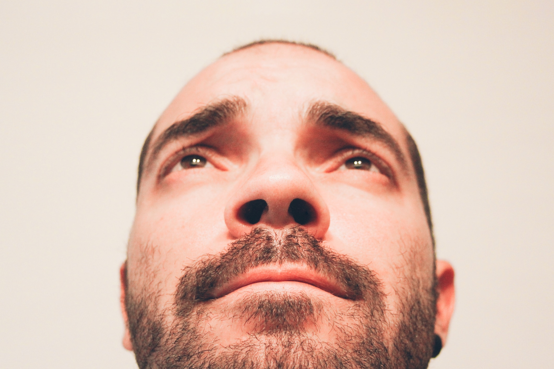 Close up of man's face looking up his nostrils