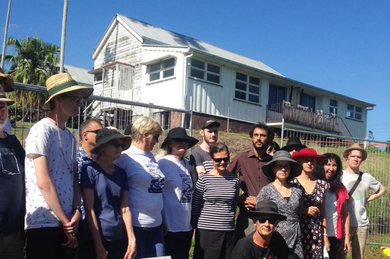 About 30 locals gather to protest the demolition of a home with heritage values at Highgate Hill in Brisbane's inner-city.
