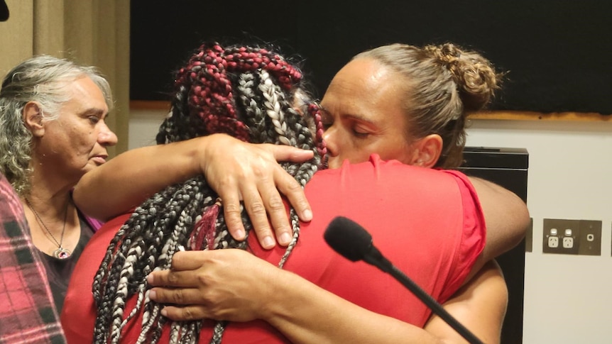 Two women hug