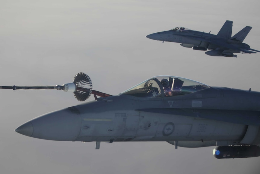 An FA-18A Hornet from Australia's Air Task Group refuels from a Royal Australian Air Force KC-30A Multi Role Tanker Transport aircraft during the first mission of Operation OKRA to be flown over Syria