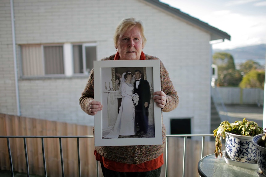 Jan Kilmartin holds a photo of her and Keith on their wedding day.