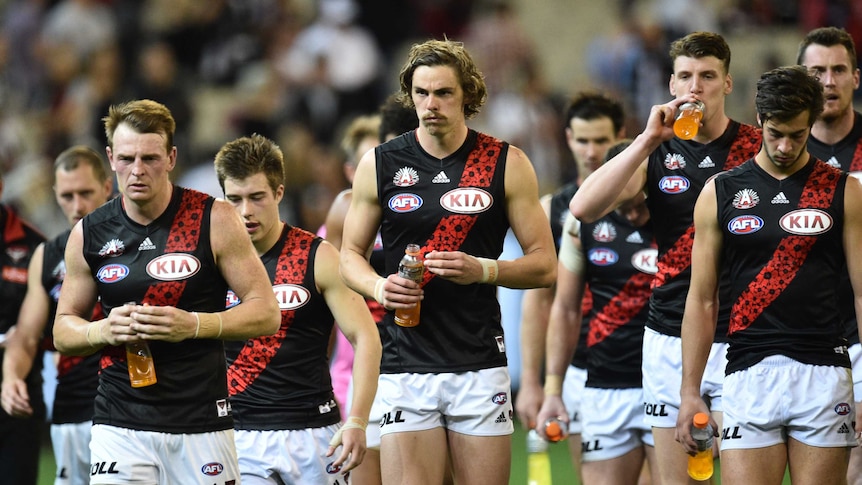 Essendon players trudge off after Anzac Day loss