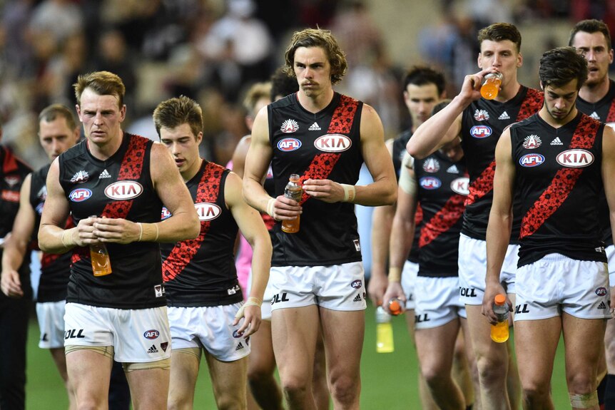 Essendon players trudge off after Anzac Day loss