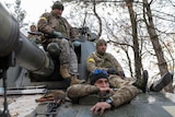 Ukrainian artillery unit members get prepared to fire towards Kherson.