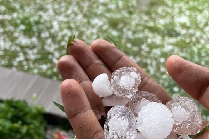 A hand holding hail stones