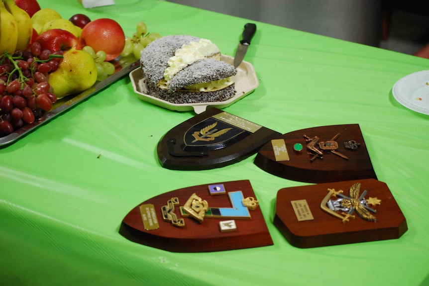 Shields and memorabilia lying on a table.