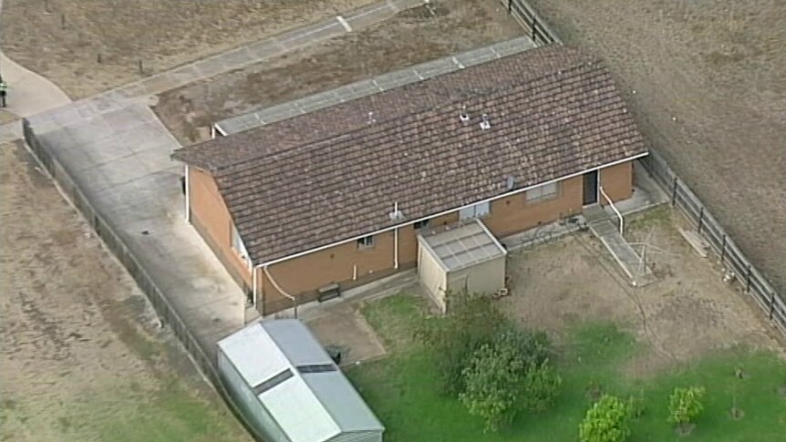 An aerial view of Vicki Ramadan's brick house, including a front and back yards.