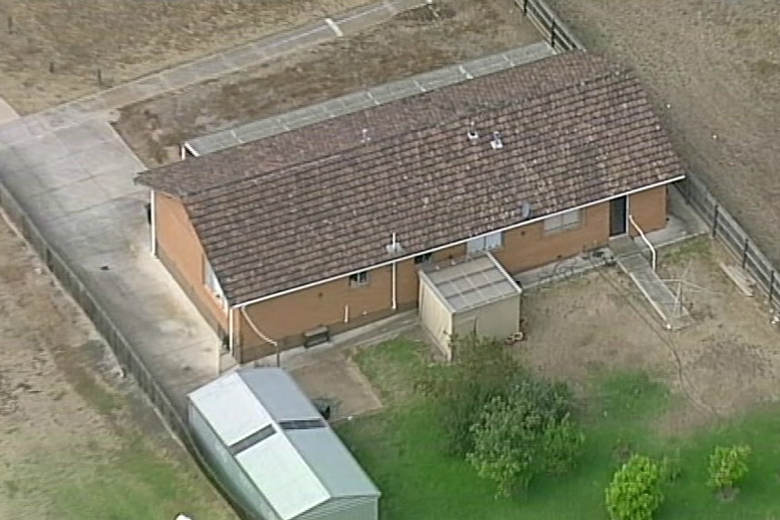 An aerial view of Vicki Ramadan's brick house, including a front and back yards.