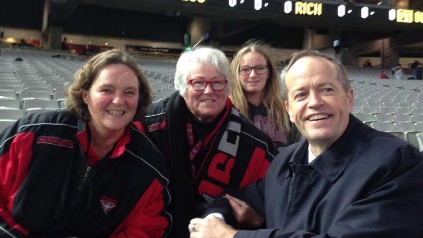 A family of Essendon fans pictured in the stands at the MCG with Labor MP Bill Shorten.