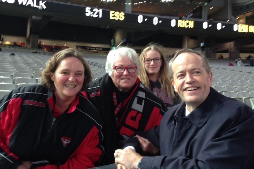 A family of Essendon fans pictured in the stands at the MCG with Labor MP Bill Shorten.