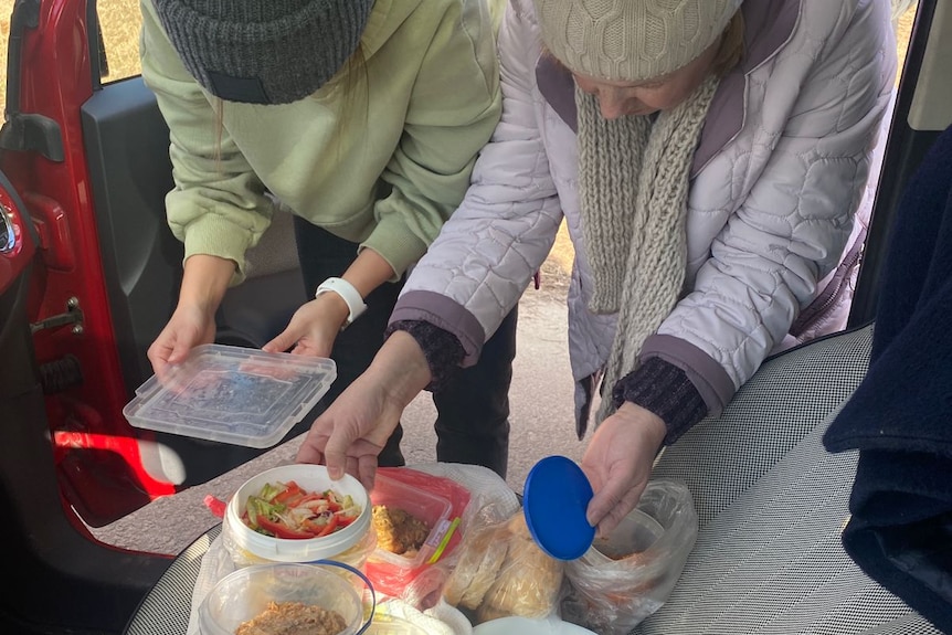 Two people preparing food.