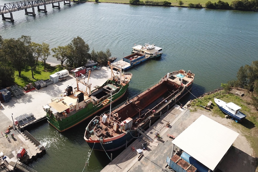 Drone image of two ships sitting in the water in a Port Macquarie shipyard