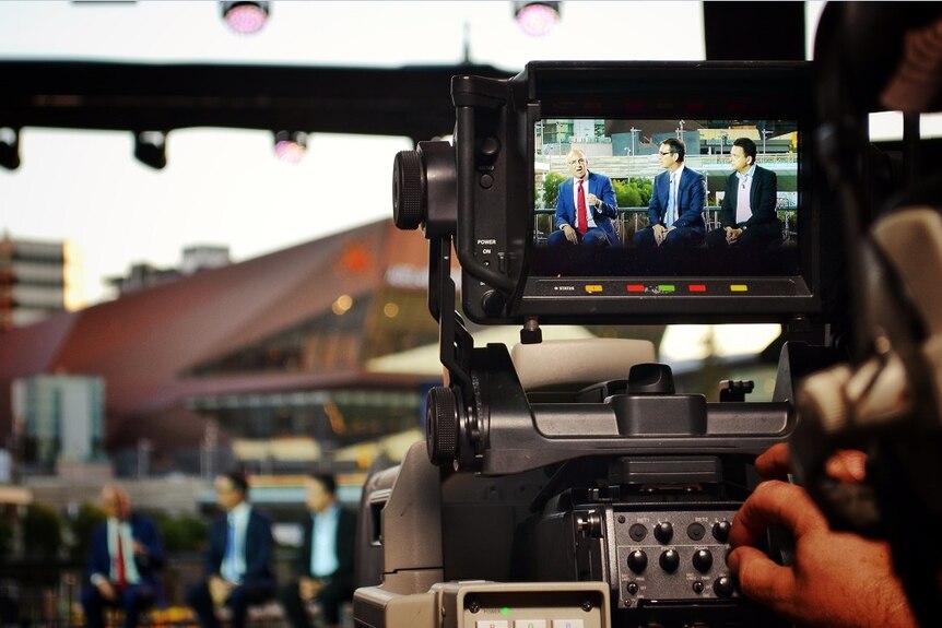 Leaders at the election debate through a camera viewfinder.