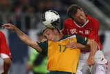 Still searching for an international goal... striker Scott McDonald battles for the ball with Switzerland's Stephan Lichtsteiner