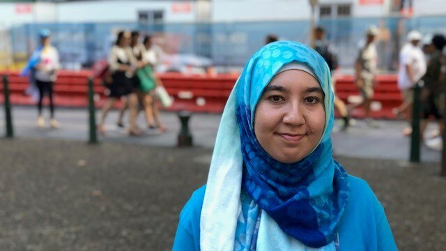 Uighur woman at Sydney protest against Chinese detention.