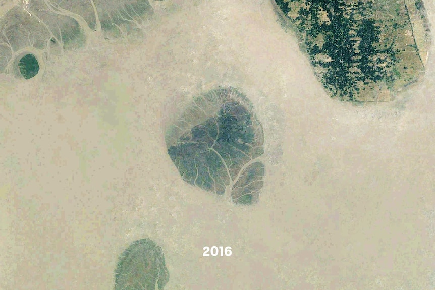 A satellite images of a small island, part of it is underwater