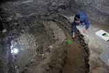 An archaeologist works on uncovering the skull-filled edifice under Mexico City.