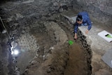 An archaeologist works on uncovering the skull-filled edifice under Mexico City.