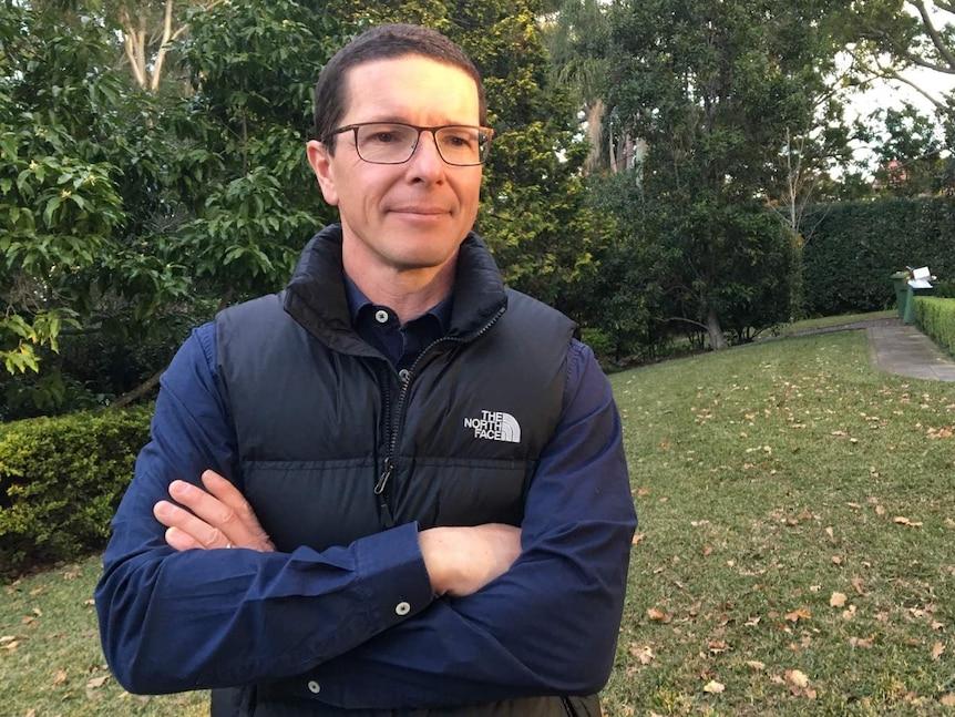 Funds manager Roger Montgomery stands in a garden.