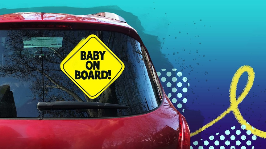 Back of car showing 'baby on board' sign in a story about whether 'baby on board' stickers actually work.