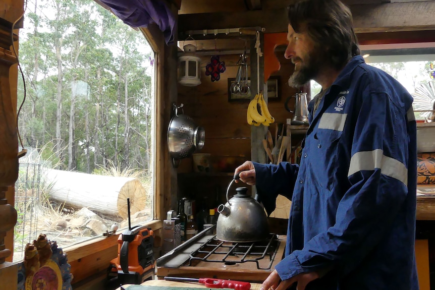 Rob making tea in his house.