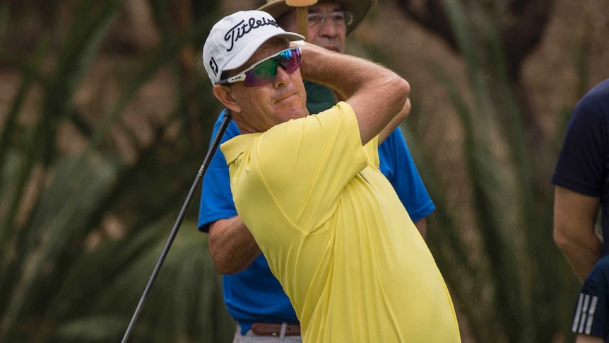 Golfer Stephen Leaney completes his swing.