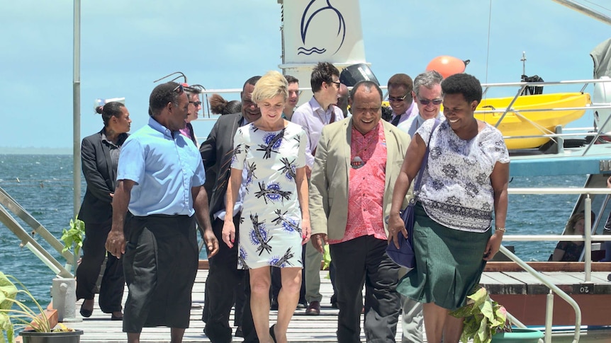 Image of Australian Foreign Minister Julie Bishop walking with a group of people, including PNG Foreign Minister Rimbink Pato