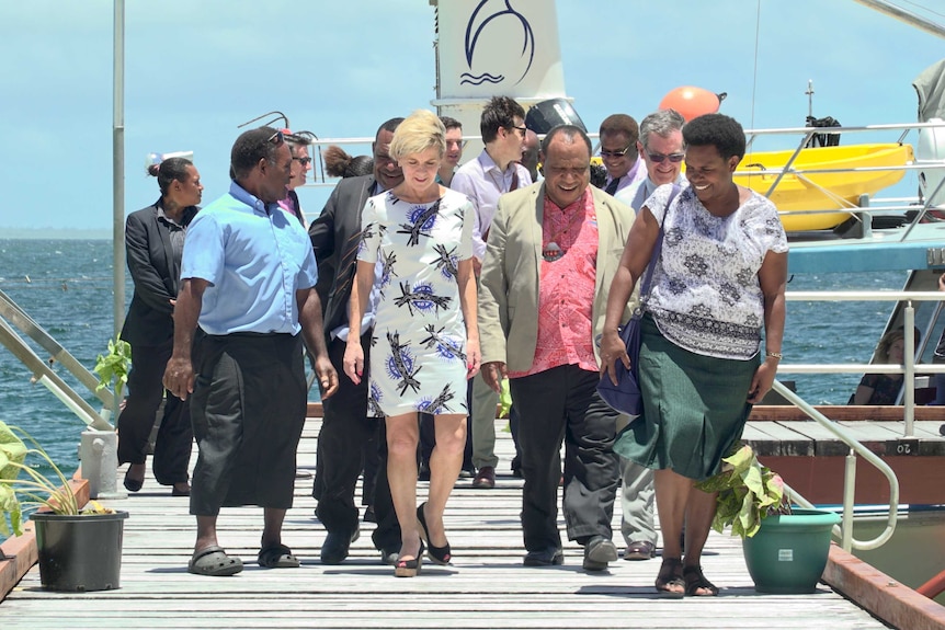 Image of Australian Foreign Minister Julie Bishop walking with a group of people, including PNG Foreign Minister Rimbink Pato