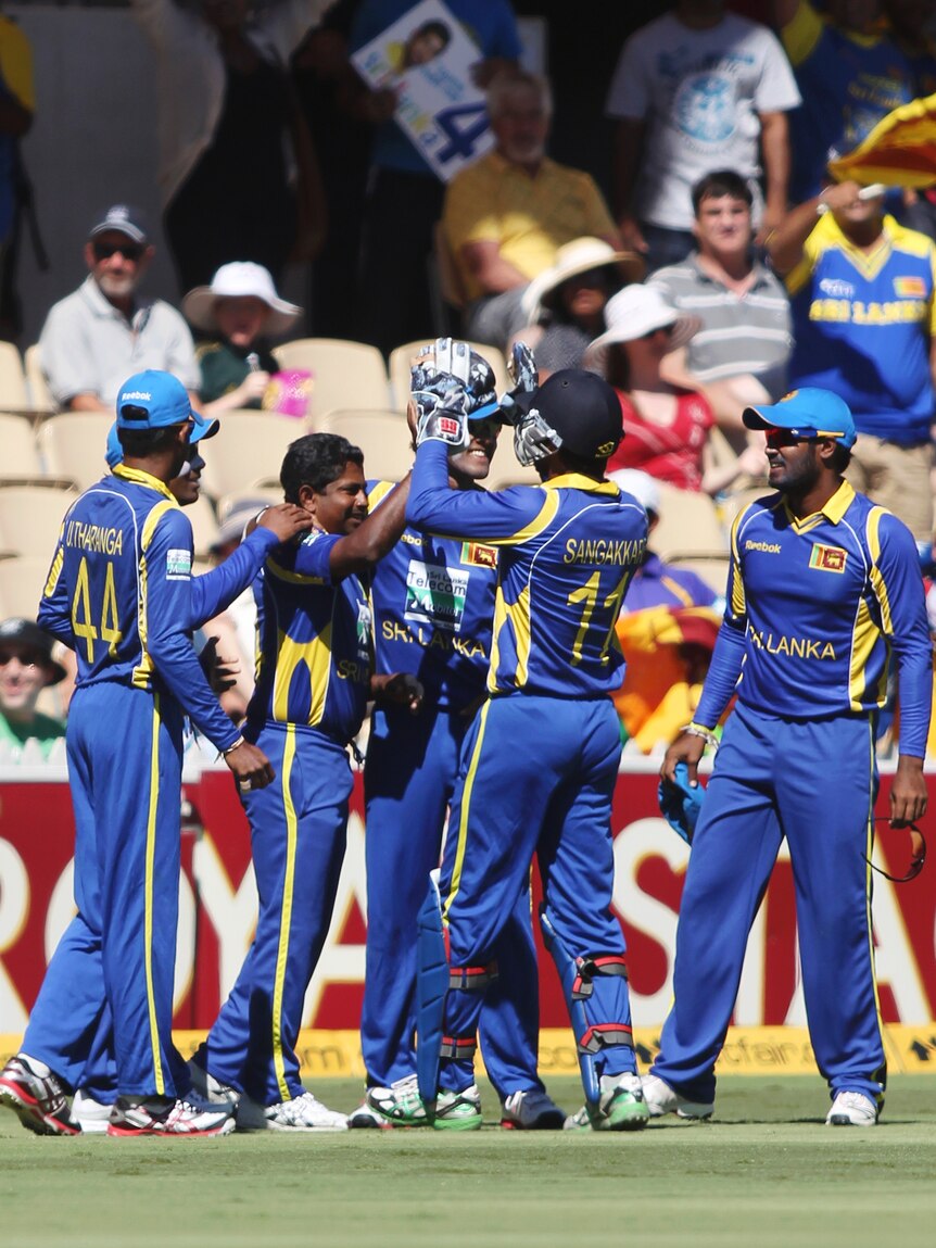 Herath and team-mates celebrate the wicket of Shane Watson.