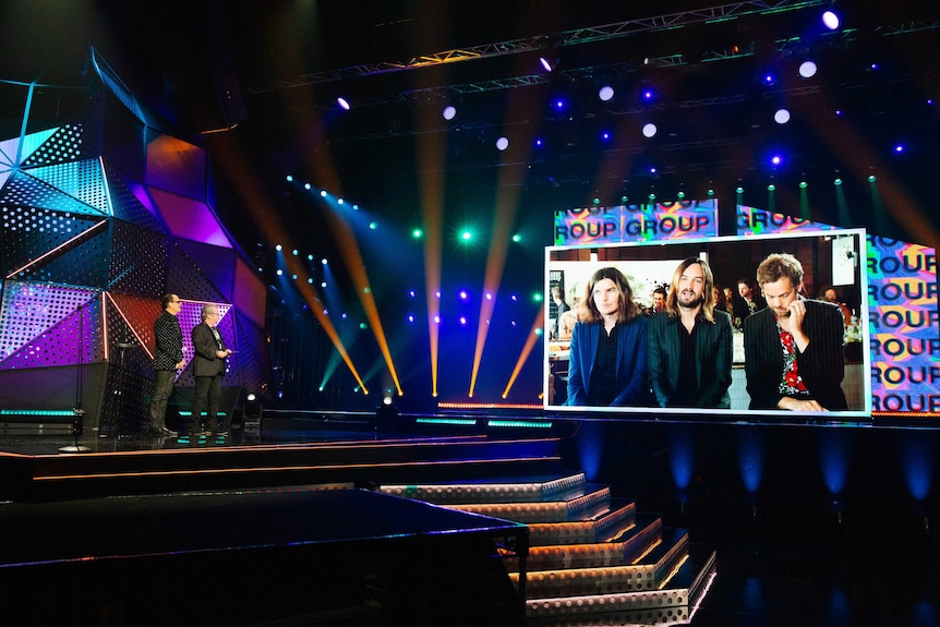 Tame Impala beamed in via live-stream on a stage.