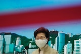 Hong Kong Chief Executive Carrie Lam wearing a face mask at a media conference.