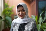 A head and shoulders shot of Siti Musdah Mulia. She is smiling against a balcony background.