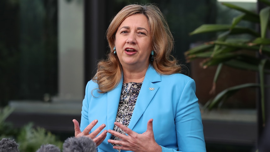 Annastacia Palaszczuk in a blue jacket outdoors at a press conference.