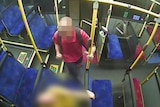 Blurred CCTV screenshot of a man making a fist before allegedly striking a passenger on a Brisbane bu