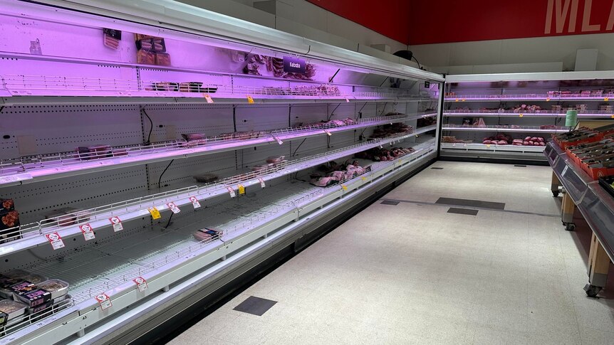 An empty stretch of shelving in a supermarket, which would normally have meat packets