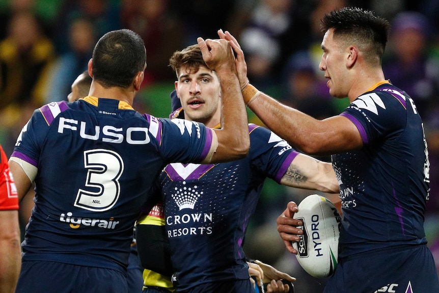 Melbourne Storm players celebrate a try