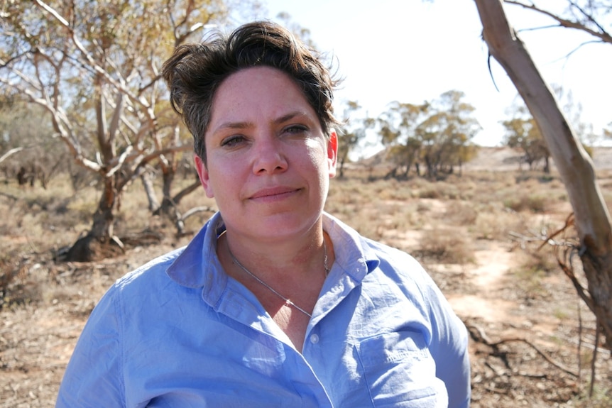 An Aboriginal woman smiles at the camera.