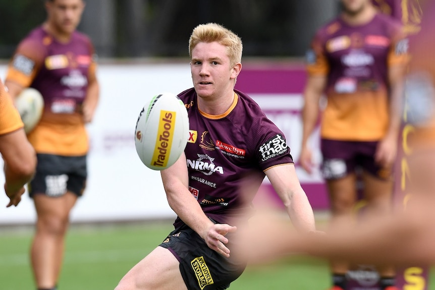 Brisbane Broncos player Tom Dearden passes the ball during training in Brisbane.