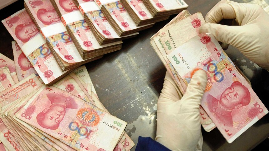 Bank of China employee counts yuan banknotes