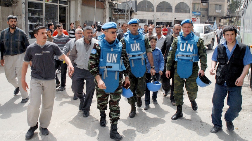 UN monitors visit a suburb of the Syrian capital Damascus