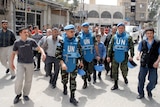 UN monitors visit a suburb of the Syrian capital Damascus