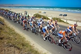 Race Leader Allan Davis leads the Tour Down Under peloton along the Esplanade at Aldinga Beach