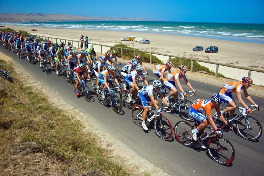 Race Leader Allan Davis leads the Tour Down Under peloton along the Esplanade at Aldinga Beach