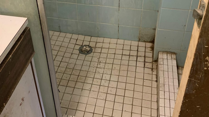 A bathroom floor with stains on it