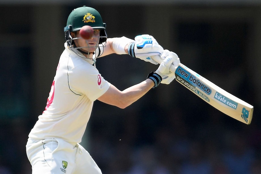 An Australian Test batsman watches the ball after playing a cut shot against New Zealand at the SCG.