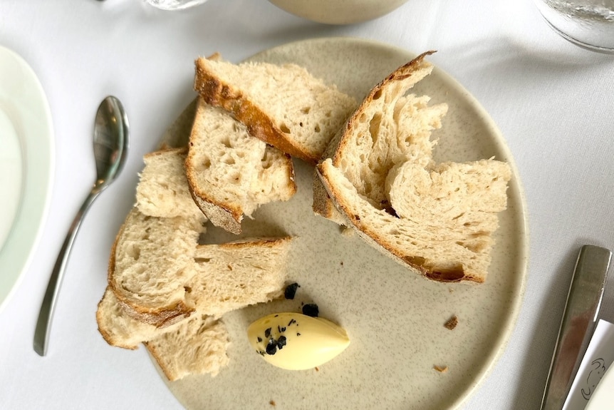 Delicious looking bread and butter on a plate.