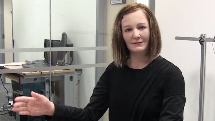 Humanoid robot Nadine makes a hand gesture while talking