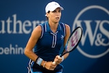 An Australian female tennis player holds her racquet in two hands during a match.